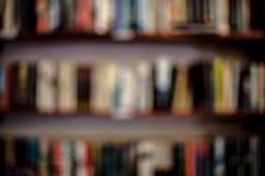 Shelves with books in a blurred background. Abstract colorful blurred background with books. Learning concept with blurred library royalty free stock photos Shelves with books in a blurred background. Abstract colorful blurred background with books. Learning concept with blurred library royalty free stock photos