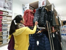 Shenzhen, China: De mensen kopen de winterkleren in Uniqlo in koud weer royalty-vrije stock foto Shenzhen, China: De mensen kopen de winterkleren in Uniqlo in koud weer royalty-vrije stock foto
