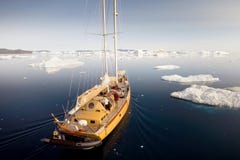 The ship sails among the icebergs in the Antarctic stock image The ship sails among the icebergs in the Antarctic stock image