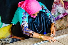 Shiraz, Iran on October 25th 2016, woman weaving carpet stock image Shiraz, Iran on October 25th 2016, woman weaving carpet stock image