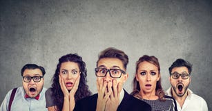 Shocked man in glasses and his scared friends stock image Shocked man in glasses and his scared friends stock image