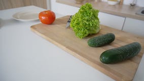 Shooting close-up of fresh vegetables on cutting board and kitch stock photo Shooting close-up of fresh vegetables on cutting board and kitch stock photo