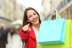 Shopper with shopping bags pointing you royalty free stock photography Shopper with shopping bags pointing you royalty free stock photography