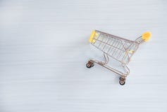 Shopping cart on white wood background stock images Shopping cart on white wood background stock images