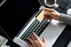 Shopping online concept. Woman holding gold credit card in hand Royalty Free Stock Image Shopping online concept. Woman holding gold credit card in hand Royalty Free Stock Image