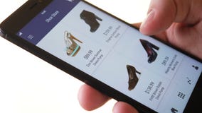 Shopping online using smartphone app and choosing shoes
