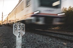 Short distance train in motion with a kilometric road sign and sunset light royalty free stock image Short distance train in motion with a kilometric road sign and sunset light royalty free stock image