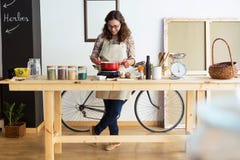Beautiful young woman cooking in organic store. Royalty Free Stock Photography Beautiful young woman cooking in organic store. Royalty Free Stock Photography