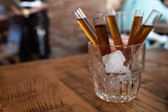 Shot of candy vodka in glass tube inside glass with ice royalty free stock photography Shot of candy vodka in glass tube inside glass with ice royalty free stock photography