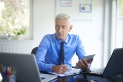 Executive businessman working in the office stock photo Executive businessman working in the office stock photo