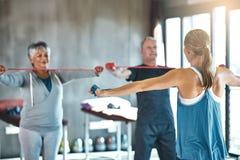 The senior years dont have to be the sedentary years. Shot of a senior man and woman using resistance bands with the