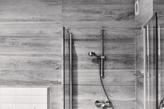 Shot of a stylish black and white bathroom with a shower head stock photo Shot of a stylish black and white bathroom with a shower head stock photo