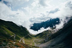 View on cloudy twisting road in mountains royalty free stock photography View on cloudy twisting road in mountains royalty free stock photography