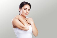 Shoulder pain. The woman holds two hands over the neck and shoulders. Dislocation. Cold. Muscle tension The concept of health. On stock images Shoulder pain. The woman holds two hands over the neck and shoulders. Dislocation. Cold. Muscle tension The concept of health. On stock images