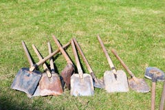 Shovels, household equipment for cleaning, arrangement of territory, digging of the earth lie on green royalty free stock images Shovels, household equipment for cleaning, arrangement of territory, digging of the earth lie on green royalty free stock images
