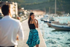 Shy flirty woman smiling to a man.Man giving a compliment to a introvert passing woman.Receiving a compliment on the street.Public royalty free stock photos Shy flirty woman smiling to a man.Man giving a compliment to a introvert passing woman.Receiving a compliment on the street.Public royalty free stock photos