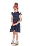 Shy little girl in the blue dress. Stock Photos Shy little girl in the blue dress. Stock Photos