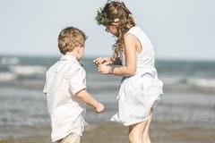 Siblings having fun on the beach Stock Photos Siblings having fun on the beach Stock Photos