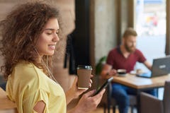 Side view of curly girl wearing yellow blouse listening to music. stock images Side view of curly girl wearing yellow blouse listening to music. stock images