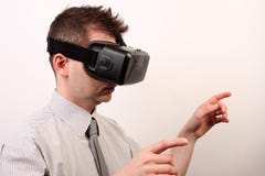 Side view of a man wearing a VR Virtual reality Oculus Rift 3D headset, touching or pointing at something with his hands stock image Side view of a man wearing a VR Virtual reality Oculus Rift 3D headset, touching or pointing at something with his hands stock image