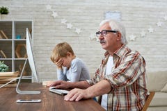 Side View of Old Man Using PC stock photo Side View of Old Man Using PC stock photo