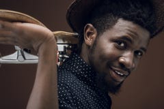 side view of smiling african american man with skate stock photography side view of smiling african american man with skate stock photography