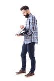 Side view of stylish bearded modern business man opening laptop computer. Stock Images Side view of stylish bearded modern business man opening laptop computer. Stock Images
