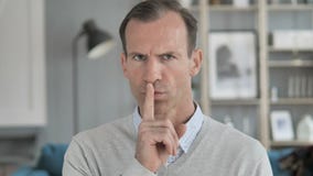 Silent, Silence Gesture by Middle Aged Man