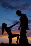 Silhouette of a cowboy looking down at a woman Royalty Free Stock Photos Silhouette of a cowboy looking down at a woman Royalty Free Stock Photos