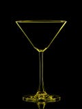 Silhouette de martini jaune sur le fond noir Photos stock