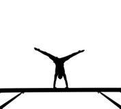 Silhouette of female gymnast on balance beam Stock Images Silhouette of female gymnast on balance beam Stock Images