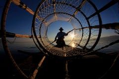 Silhouette of intha fisherman against the sunset sky Stock Image Silhouette of intha fisherman against the sunset sky Stock Image