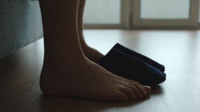 Silhouette of legs of young adult man and a slippers Stock Photos Silhouette of legs of young adult man and a slippers Stock Photos