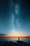 Silhouette of a man looking up on stars of the milky way