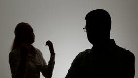 Silhouette of a man and a woman. Family quarrel, the woman shouts at the man and emotionally gesticulating hands, stock footage Silhouette of a man and a woman. Family quarrel, the woman shouts at the man and emotionally gesticulating hands, stock footage