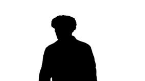 Silhouette Mature surgery in a mask walking. Front view. stock footage Silhouette Mature surgery in a mask walking. Front view. stock footage