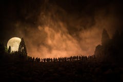 Silhouette Of A Large Crowd Of People In Forest At Night Watching At Rising Big Full Moon. Decorated Background With Night Sky Wit Royalty Free Stock Photos