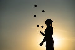 Silhouette Of A Man Juggling With Balls At Sunset Stock Photos