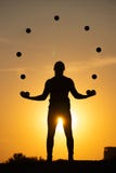Silhouette Of A Man Juggling With Balls At Sunset Royalty Free Stock Photography