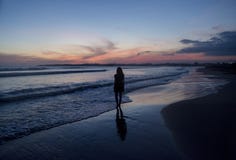 Silhouette Of A Young Woman Walking On The Beach During Sunset Time Royalty Free Stock Images Silhouette Of A Young Woman Walking On The Beach During Sunset Time Royalty Free Stock Images