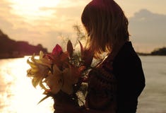 Silhouette Of A Young Woman With Lilies Stock Image