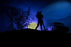 Silhouette Of Couple Kissing Under Full Moon. Guy Kiss Girl Hand On Full Moon Silhouette Background. Valentine`s Day Decor Concept Stock Image
