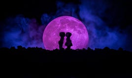 Silhouette Of Couple Kissing Under Full Moon. Guy Kiss Girl Hand On Full Moon Silhouette Background. Valentine`s Day Decor Concept Royalty Free Stock Image