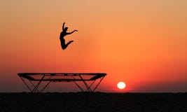 Silhouette Of Female Gymnast Jumping On Trampoline Royalty Free Stock Image