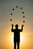 Silhouette Of Juggler With Balls On Colorful Sunset Royalty Free Stock Image