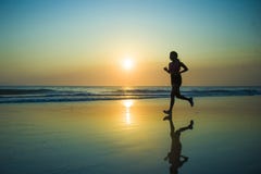 Silhouette Of Young Happy And Attractive African American Runner Woman Exercising In Running Fitness Workout At Beautiful Beach Jo Stock Image