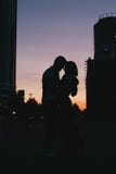 Silhouette Of Young Happy Couple In Love Kissing On City Street At Sunset Royalty Free Stock Photos