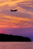 Silhouette of Passenger Airplane Landing at sunset. Above the sea Royalty Free Stock Images Silhouette of Passenger Airplane Landing at sunset. Above the sea Royalty Free Stock Images