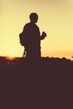 Silhouette of the person holding in hand drink in a bottle. Outdoors photo Royalty Free Stock Photography Silhouette of the person holding in hand drink in a bottle. Outdoors photo Royalty Free Stock Photography