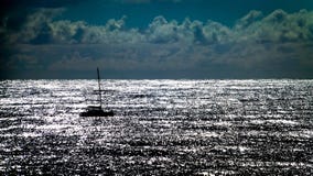 Silhouette of a sailing boat at sunset with reflecting sea royalty free stock images Silhouette of a sailing boat at sunset with reflecting sea royalty free stock images